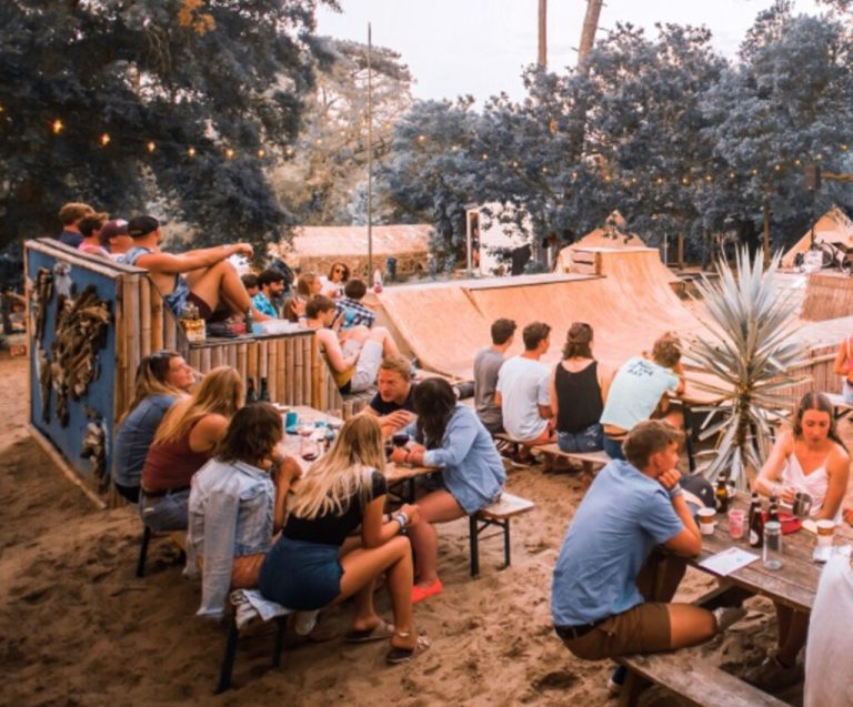 Wide landscape shot at sunset of rolling green hills.